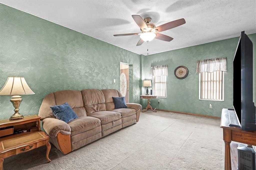 1315 South Main Street Burgettstown, PA 15021 - Photo 6 of 24 a living room with furniture ceiling fan and a window