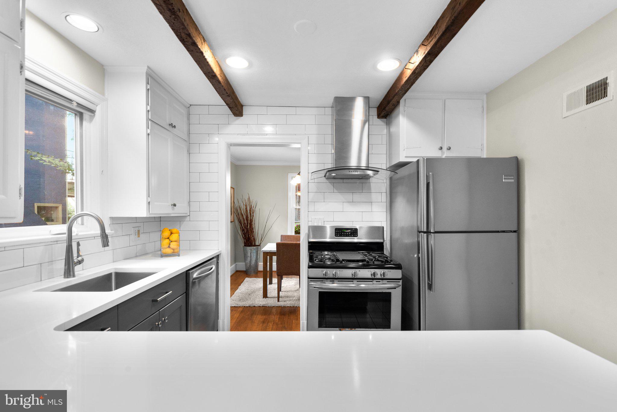 807 Islington Street Silver Spring, MD 20910 - Photo 16 of 49 Kitchen with wood beams and an exposed brick wall