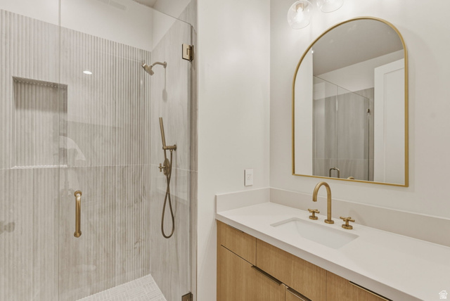 923 North Emery Lane Elk Ridge, UT 84651 - Photo 71 of 101 Contemporary bathroom featuring a frameless glass shower enclosure with fluted tile walls and a built-in niche