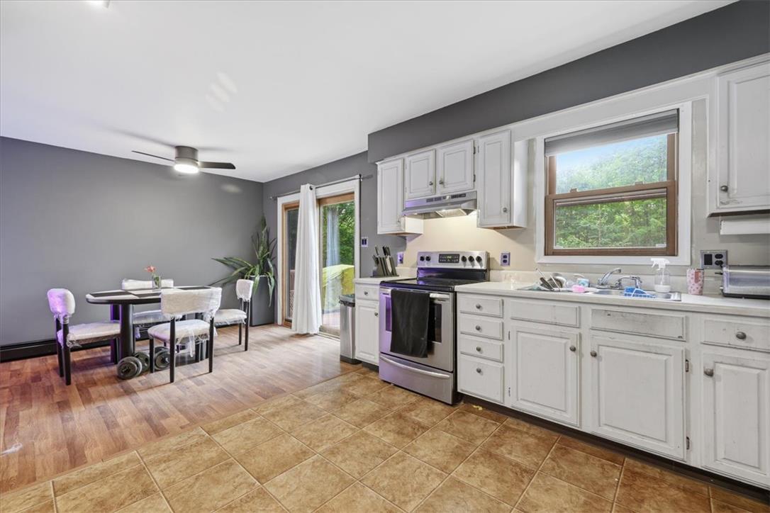 520 Highland Hill Road Jim Thorpe, PA 18235 - Photo 15 of 83 A functional kitchen boasts ample counter space, white cabinetry, and convenient outdoor access.
