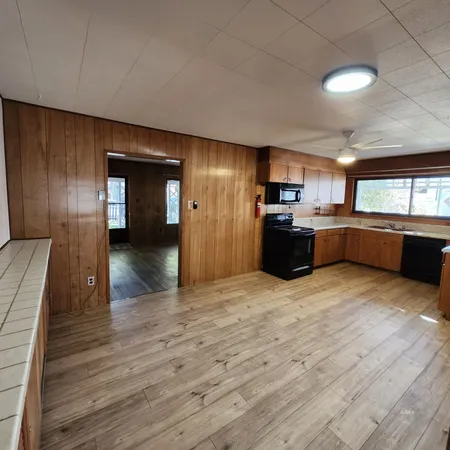 a kitchen with a sink and wooden cabinets