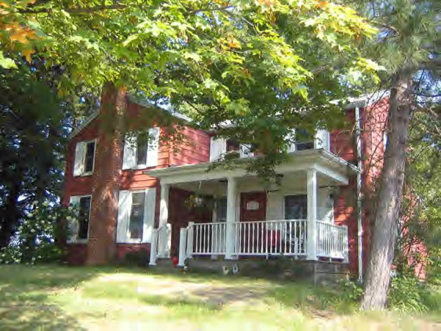 3237 Georgetown Road Polk, PA 16342 - Photo 1 of 1 a front view of a house with a garden