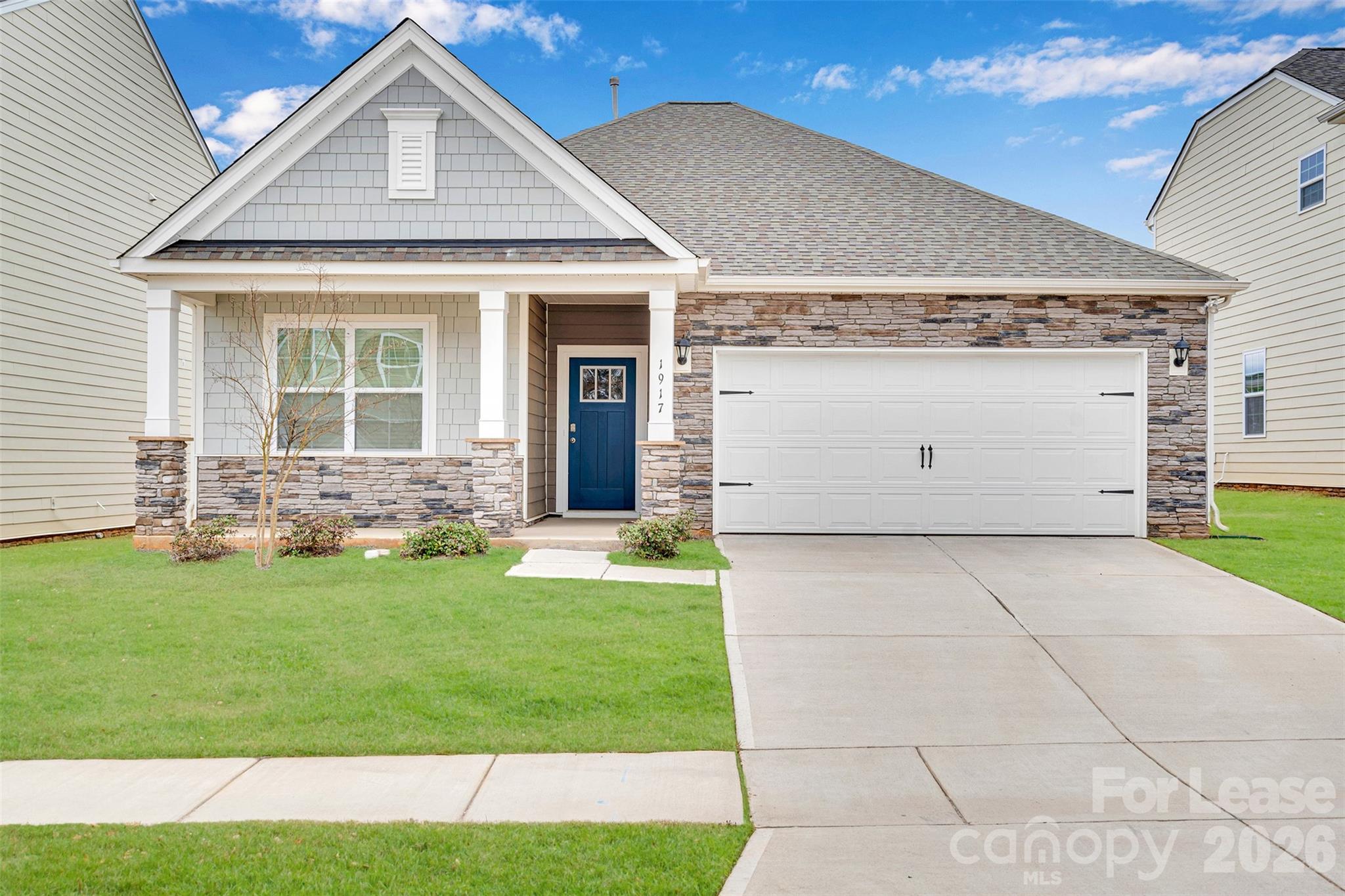 1917 Vanderlyn Street Monroe, NC 28112 - Photo 1 of 14 a front view of a house with a yard and garage