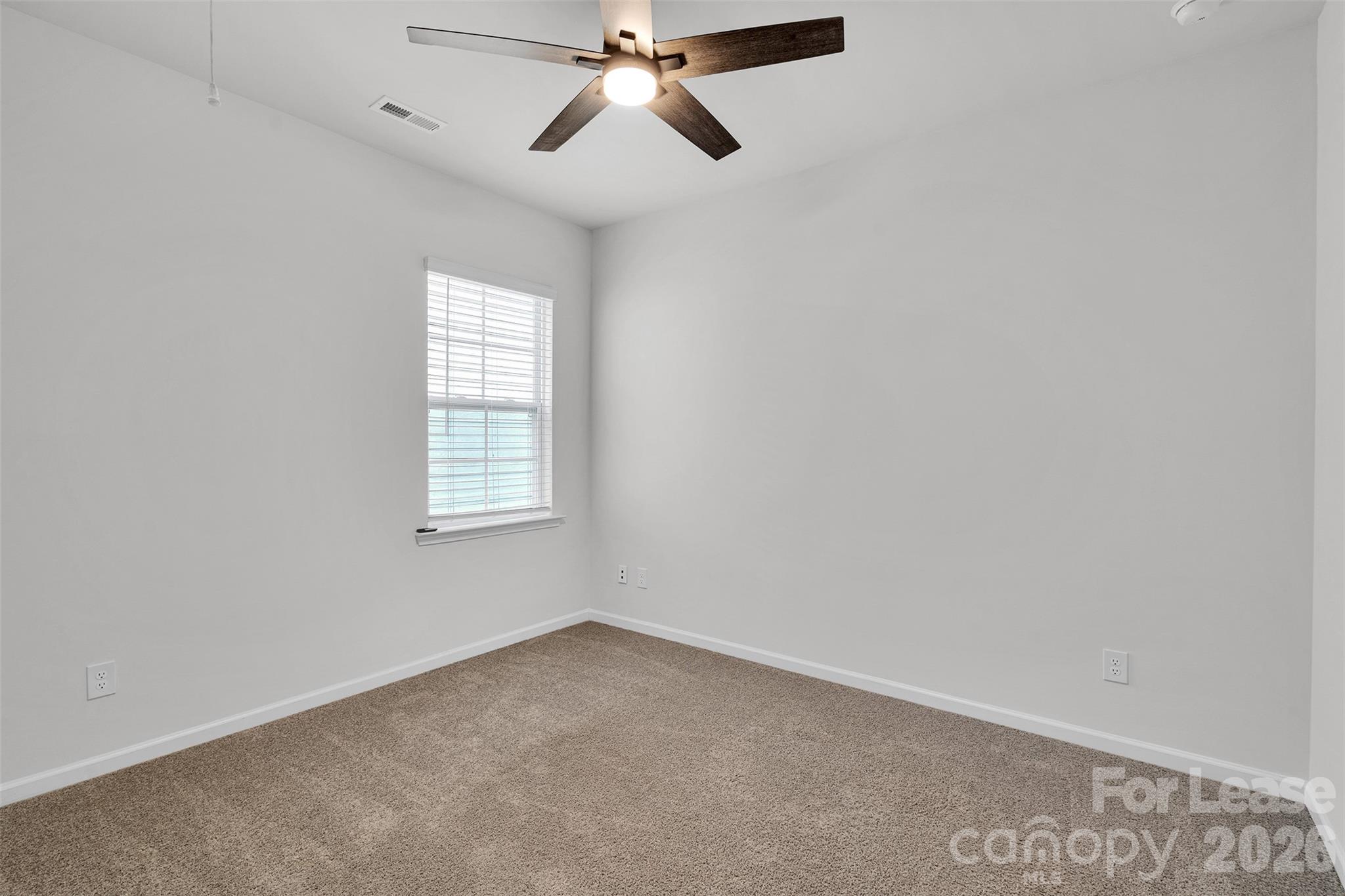 1917 Vanderlyn Street Monroe, NC 28112 - Photo 7 of 14 an empty room with windows and fan