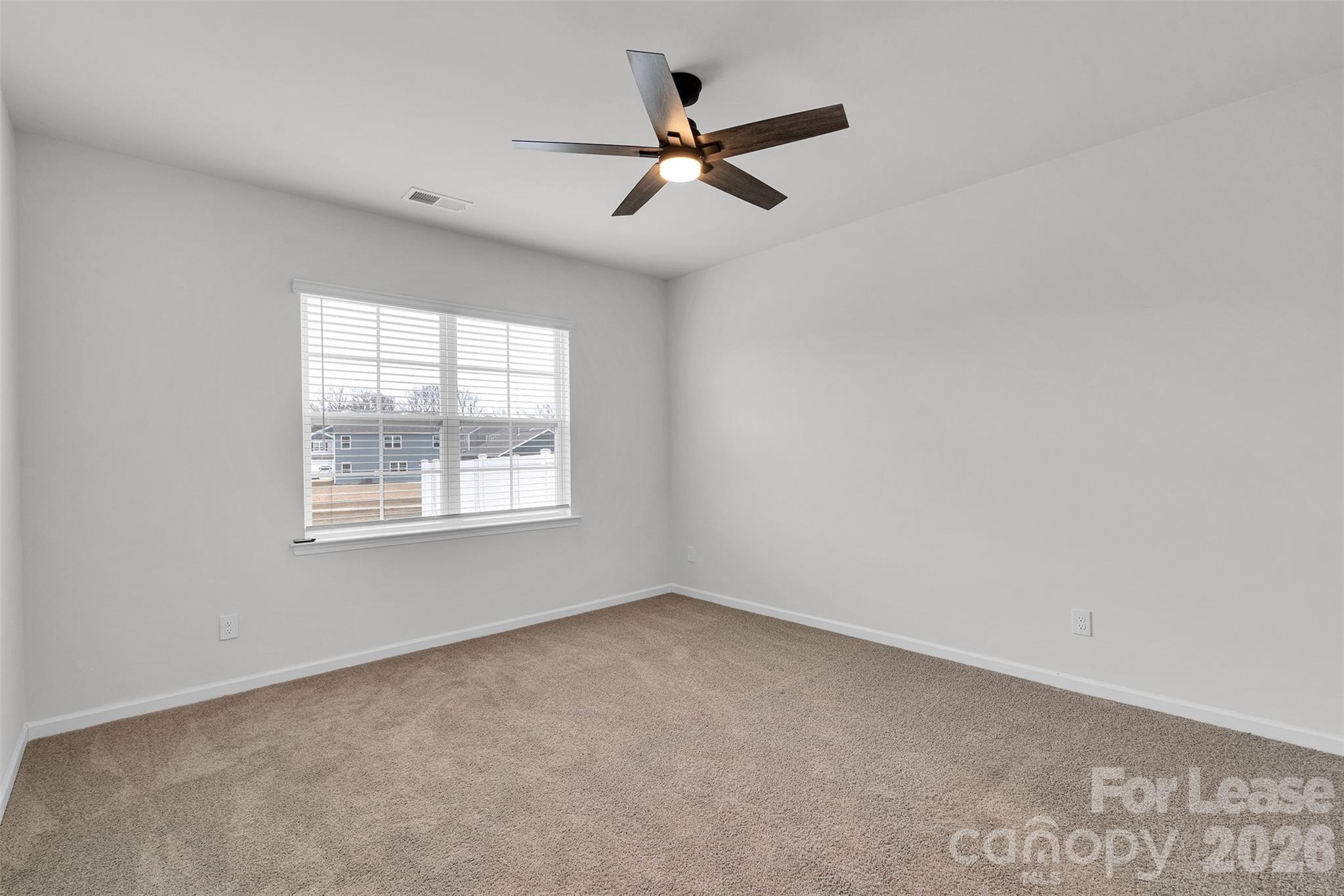 1917 Vanderlyn Street Monroe, NC 28112 - Photo 10 of 14 an empty room with a window and a fan