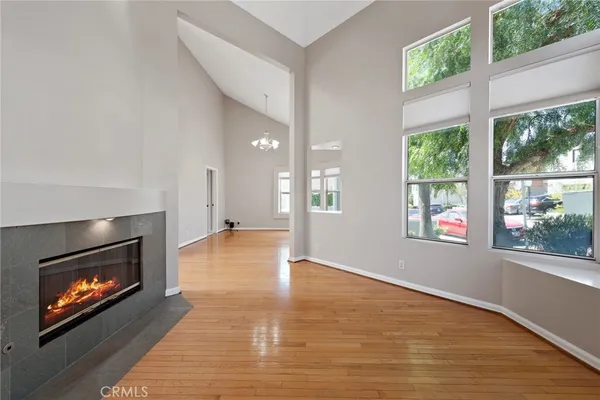 a view of an empty room with a fireplace and a window