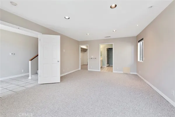 a spacious bathroom with a tub sink and mirror