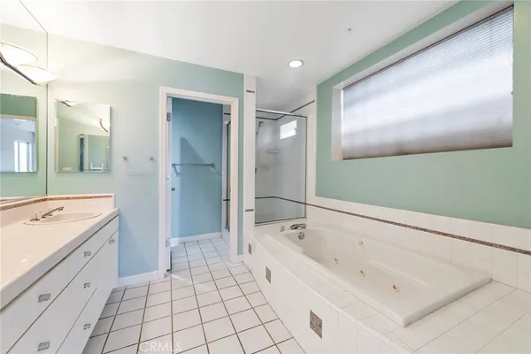 a view of a house with barbeque and wooden fence