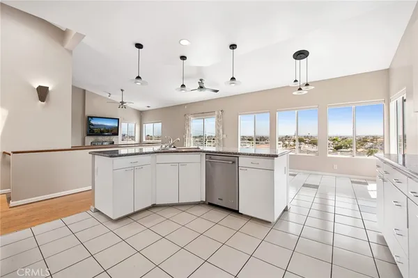 a large white kitchen with cabinets and stainless steel appliances