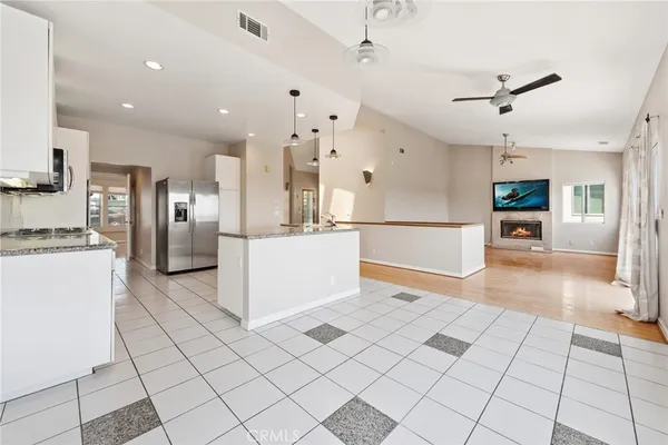a kitchen with kitchen island granite countertop cabinets and stainless steel appliances