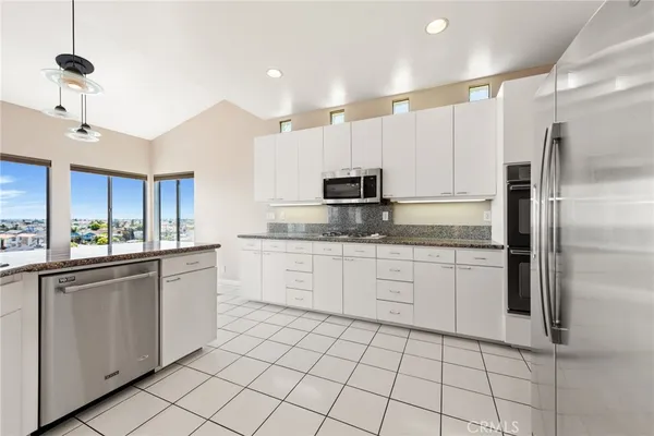 a view of a kitchen with cabinets and wooden floor