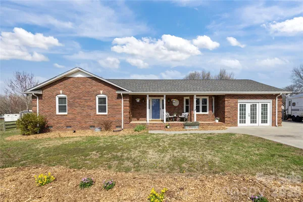 a house view with a sitting space and garden
