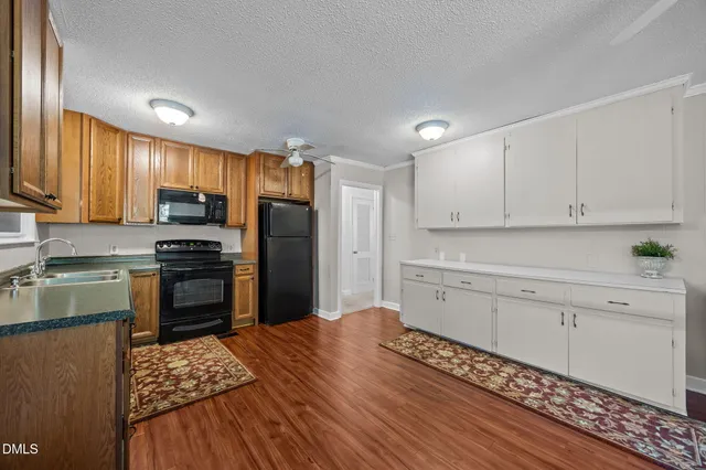 a kitchen with a refrigerator stove and sink