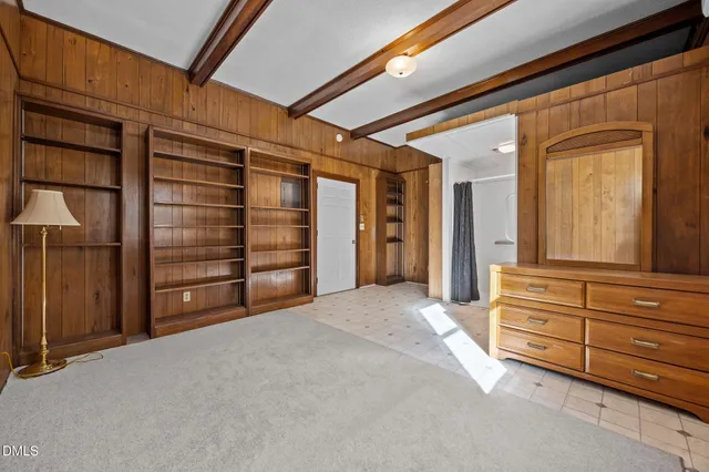 a view of a house with a yard and potted plants