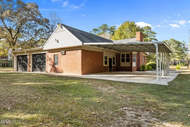 a front view of a house with yard and garage