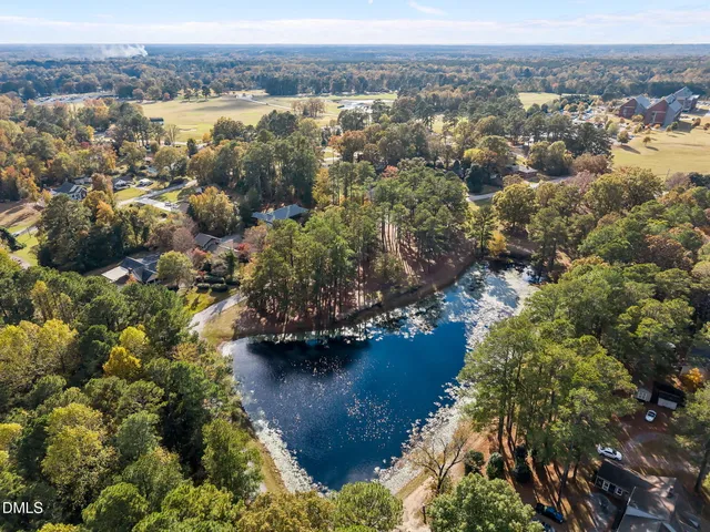 an aerial view of house with yard swimming pool and outdoor seating