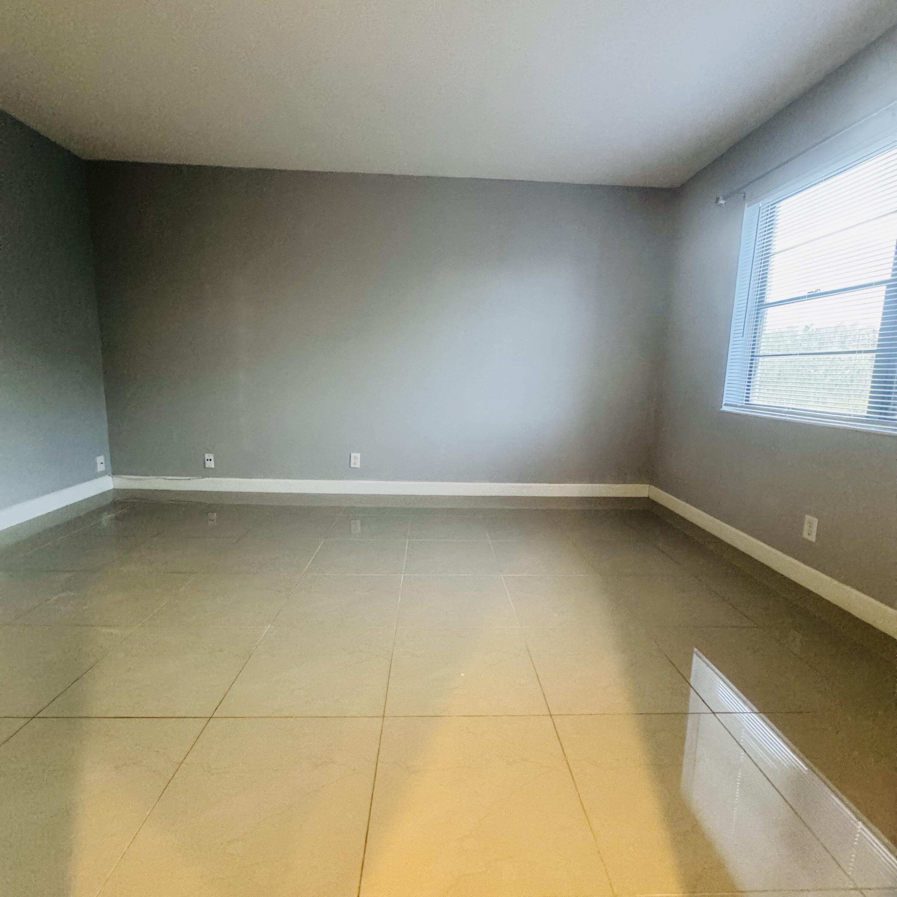 9235 Southwest 8th Street, Unit 503 Boca Raton, FL 33428 - Photo 8 of 17 an empty room with a window