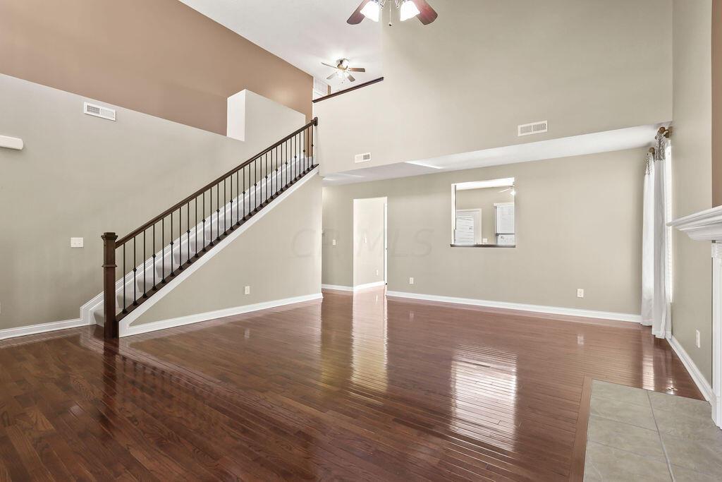 6163 Jennis Road Westerville, OH 43081 - Photo 3 of 44 • Hardwood flooring
• Tan painted walls
• Vaulted ceiling
• Lighted ceiling fan
• Gas log fireplace with
mantle
• Closet under stairs
• 2” blinds
• Drapes remain