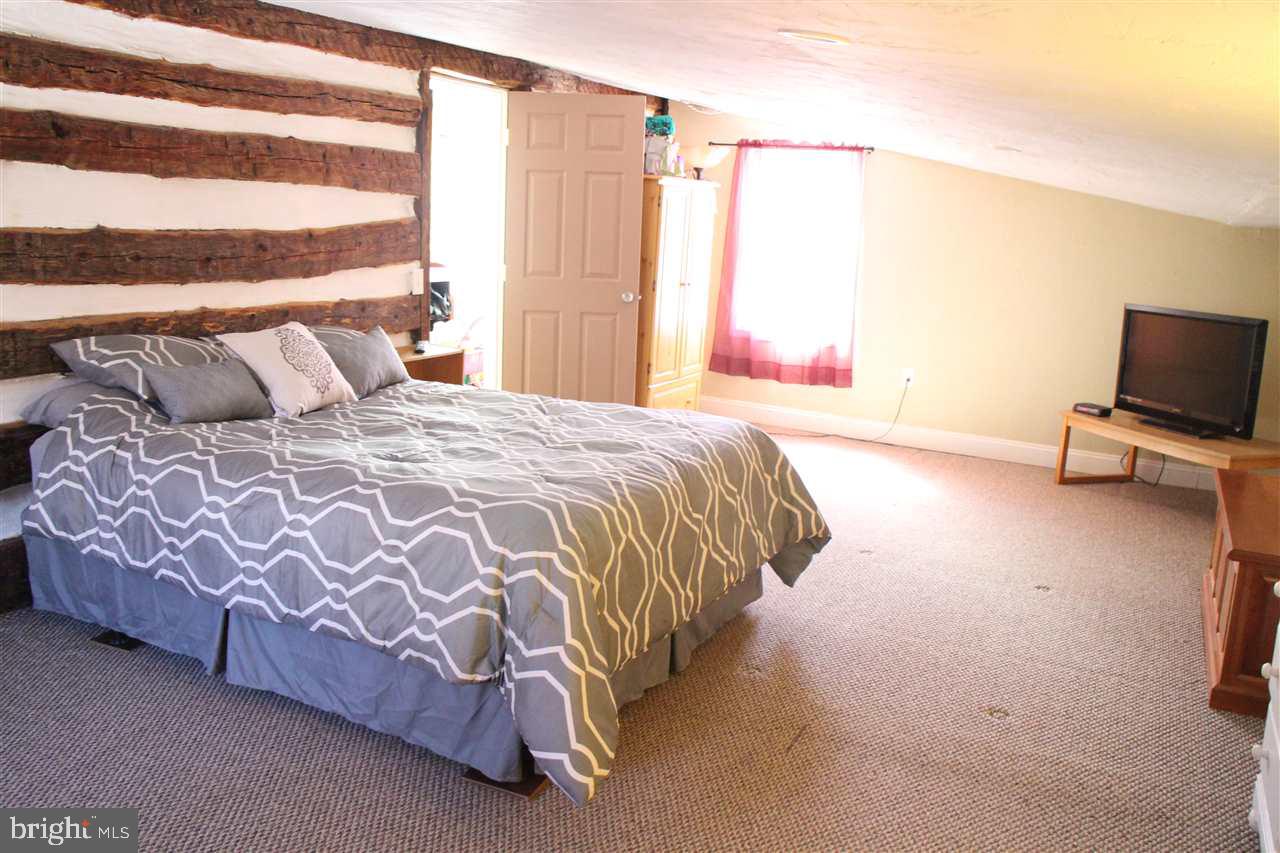 865 Bremer Road Dover, PA 17315 - Photo 14 of 33 a bedroom with a bed and a flat screen tv