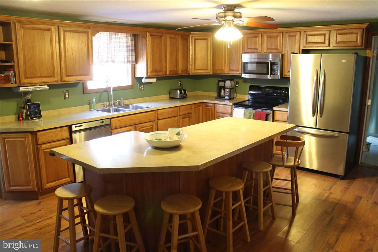 865 Bremer Road Dover, PA 17315 - Photo 7 of 33 a kitchen with stainless steel appliances a sink a table and chairs