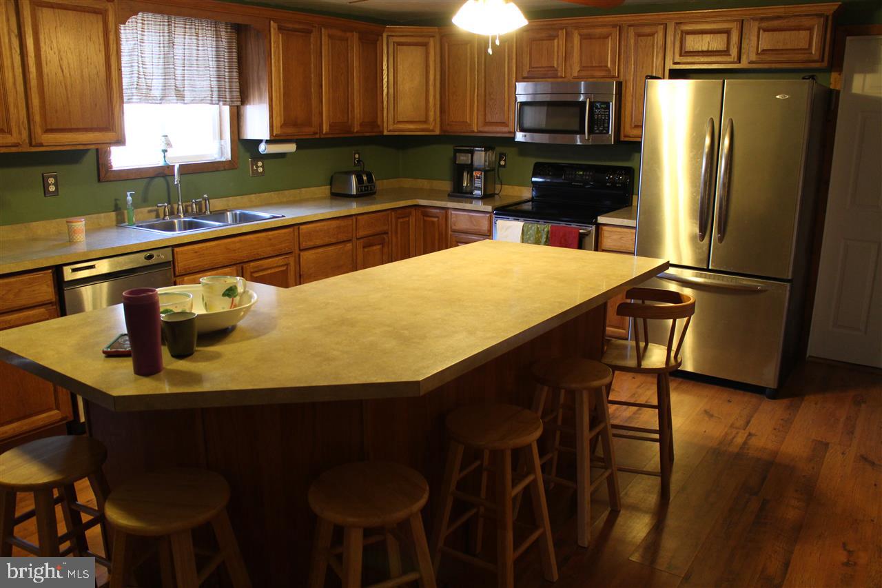 865 Bremer Road Dover, PA 17315 - Photo 8 of 33 a kitchen with stainless steel appliances a table chairs microwave and refrigerator