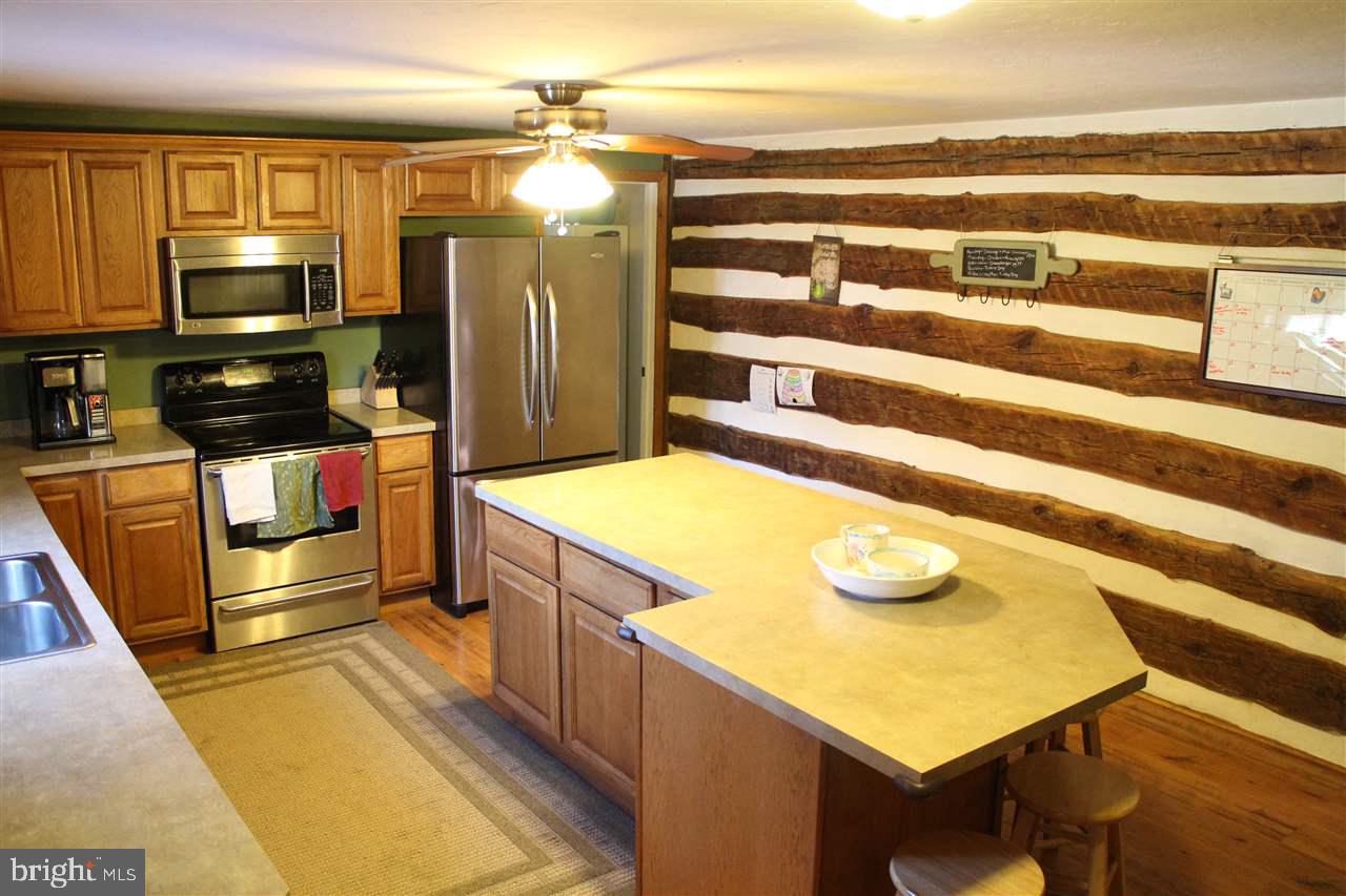 865 Bremer Road Dover, PA 17315 - Photo 9 of 33 a kitchen with stainless steel appliances a stove and a refrigerator