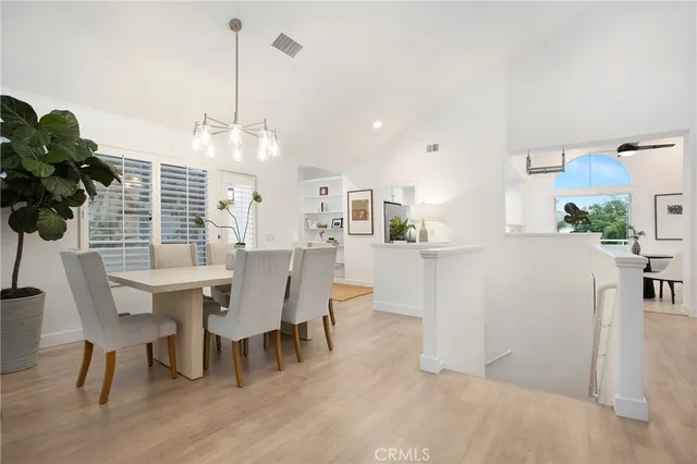 a view of a dining room with furniture and chandelier