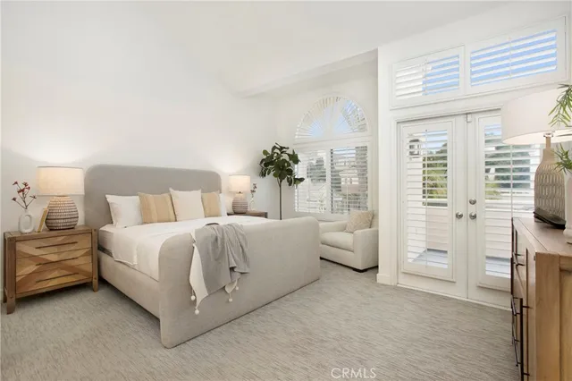 a bedroom with a bed and a mirror