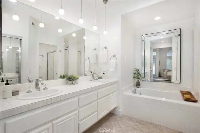 a bathroom with a tub shower and sink