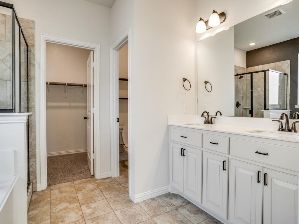3225 Greymoore Drive Anna, TX 75409 - Photo 11 of 16 a spacious bathroom with a double vanity sink a mirror and a shower
