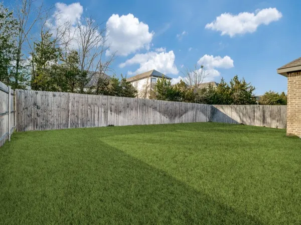 a view of yard with swimming pool and green space