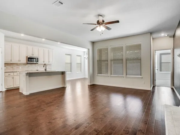 a view of kitchen with sink and wooden floor