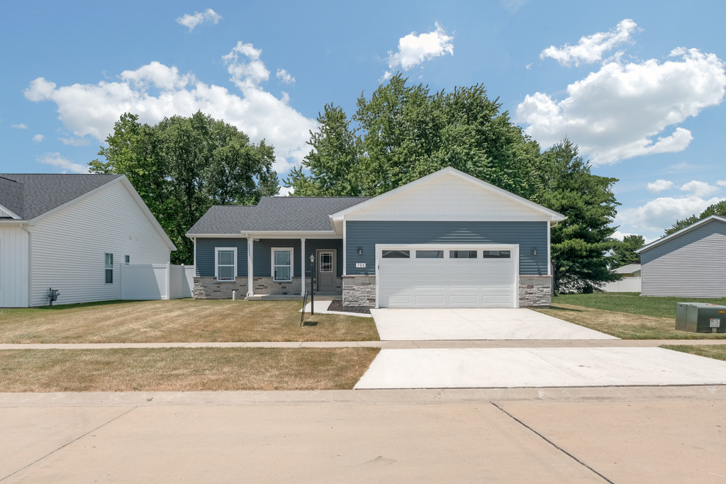 708 Justice Street Tuscola, IL 61953 - Photo 2 of 3 a front view of a house with a yard and garage