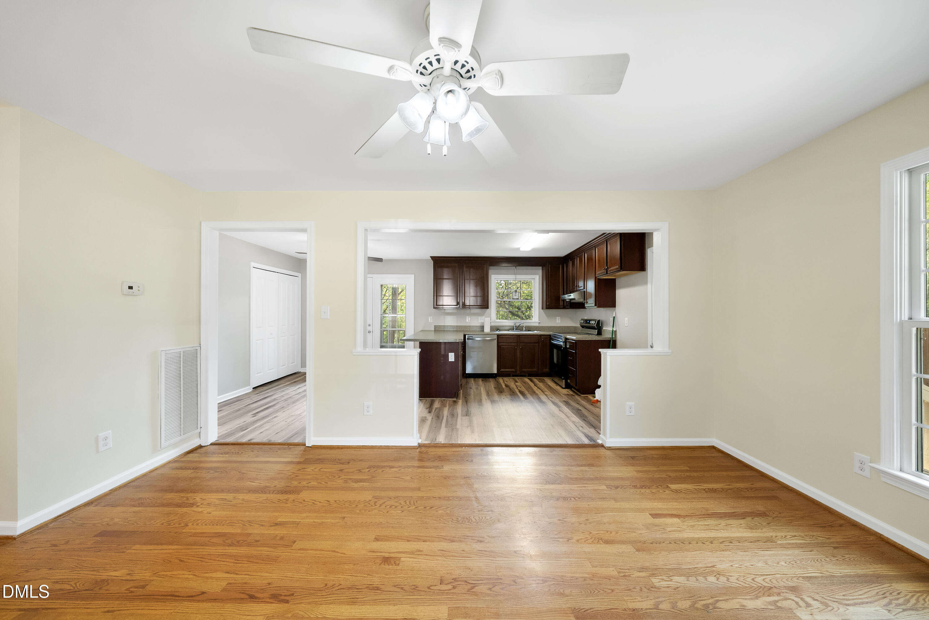 2123 Shenandoah Road Raleigh, NC 27603 - Photo 16 of 26 a view of a kitchen with kitchen island a sink wooden floor and a refrigerator