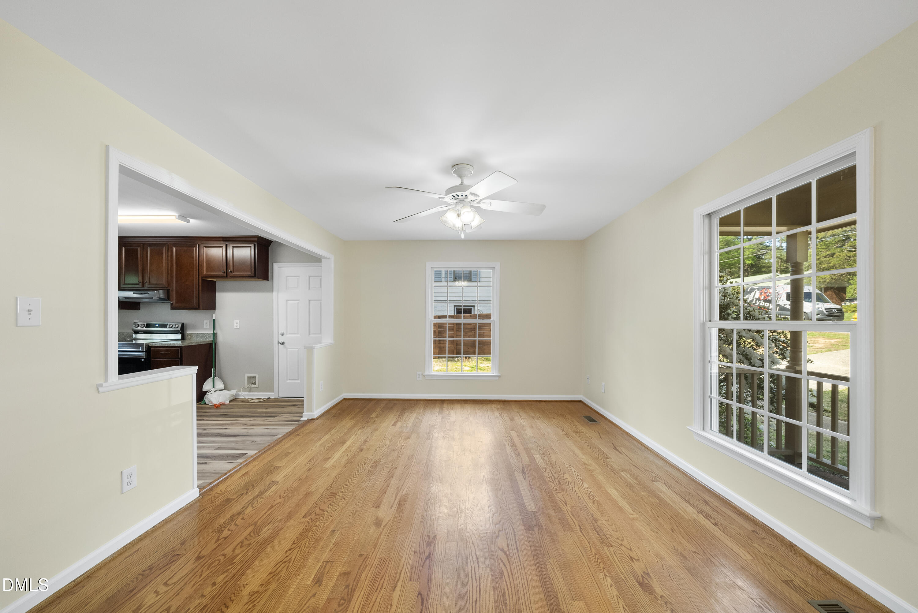 2123 Shenandoah Road Raleigh, NC 27603 - Photo 17 of 26 a view of a livingroom with wooden floor and a kitchen