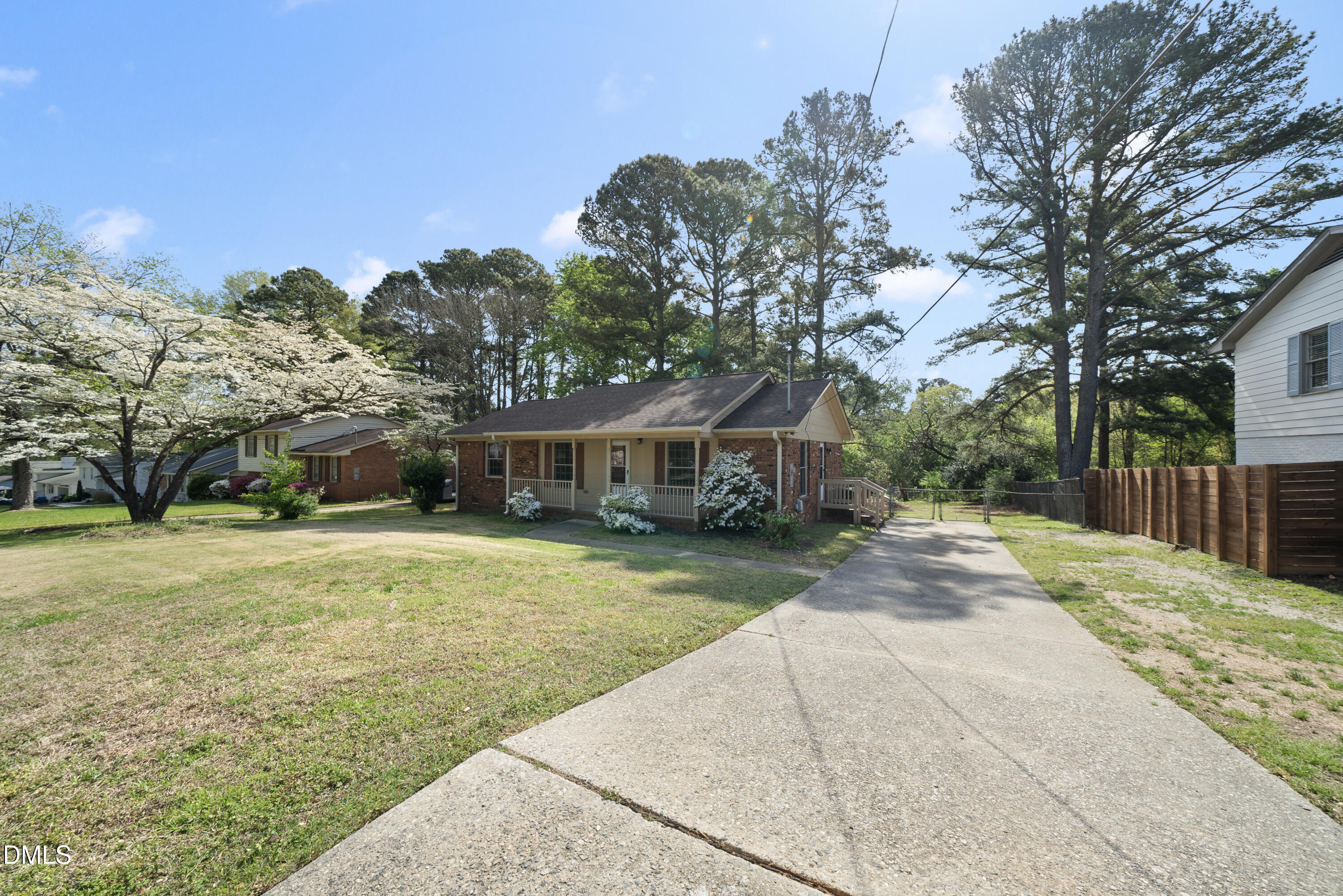 2123 Shenandoah Road Raleigh, NC 27603 - Photo 3 of 26 a front view of a house with a garden and trees