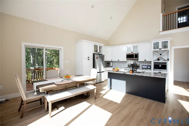 a kitchen with stainless steel appliances granite countertop a refrigerator and a stove