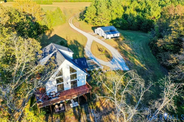 a view of house with yard and swimming pool