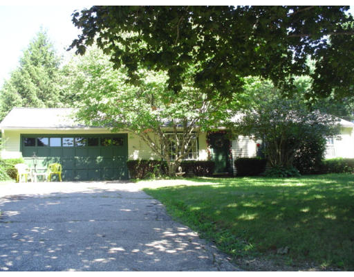 129 Chestnut Hill Road Groton, MA 01450 - Photo 2 of 8 a front view of a house with a yard and garage