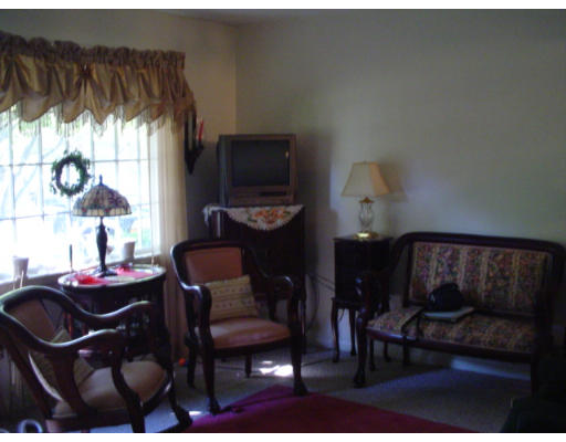 129 Chestnut Hill Road Groton, MA 01450 - Photo 6 of 8 a living room with furniture a window and a flat screen tv