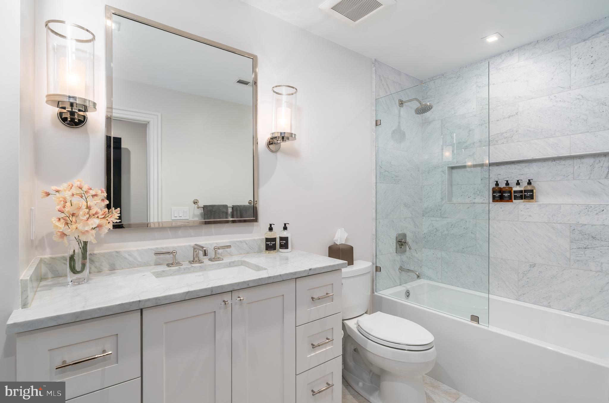 1639 35th Street Northwest Washington, DC 20007 - Photo 12 of 60 a bathroom with a double vanity sink toilet mirror and shower