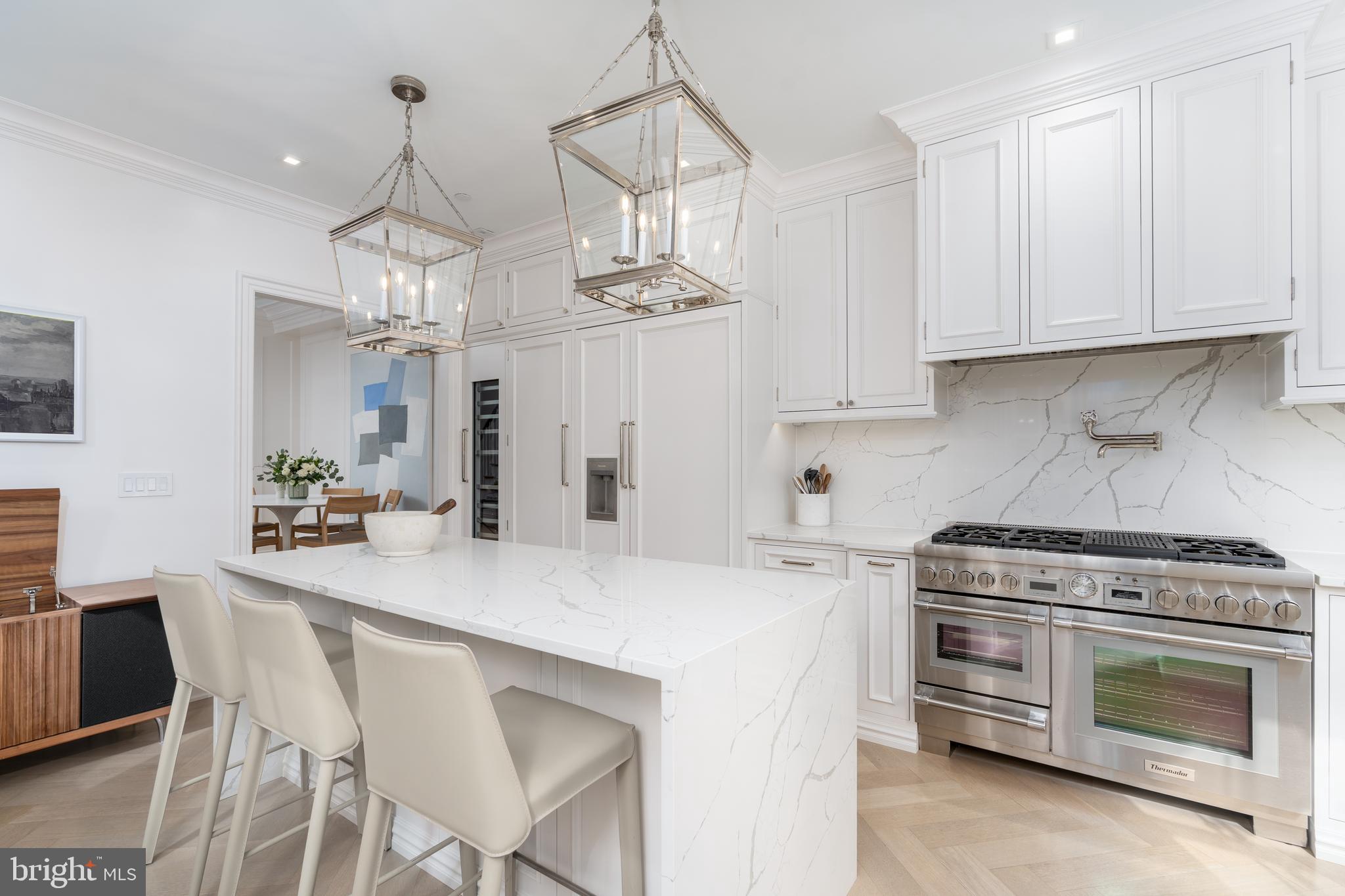 1639 35th Street Northwest Washington, DC 20007 - Photo 27 of 60 a kitchen with stainless steel appliances a stove a table and chairs in it