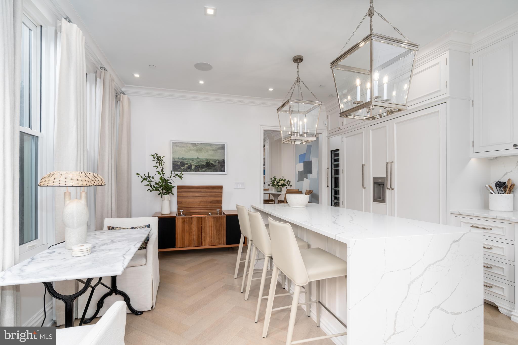 1639 35th Street Northwest Washington, DC 20007 - Photo 28 of 60 a kitchen with refrigerator cabinets dining table and chairs