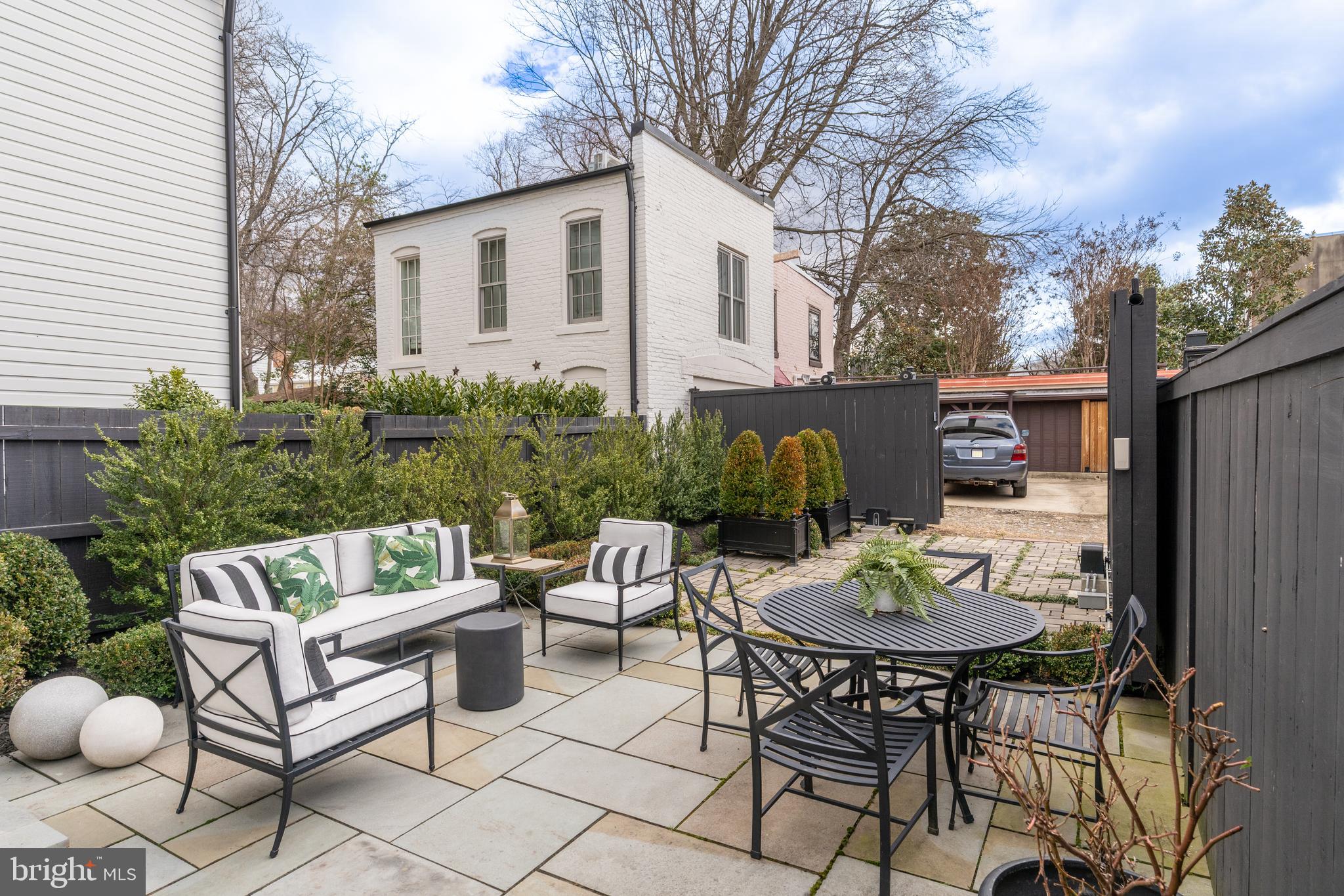 1639 35th Street Northwest Washington, DC 20007 - Photo 52 of 60 a view of a patio with table and chairs and potted plants