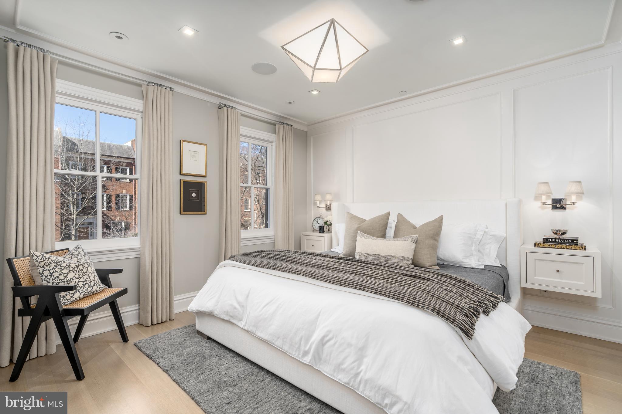 1639 35th Street Northwest Washington, DC 20007 - Photo 6 of 60 a bedroom with a large bed and a chandelier