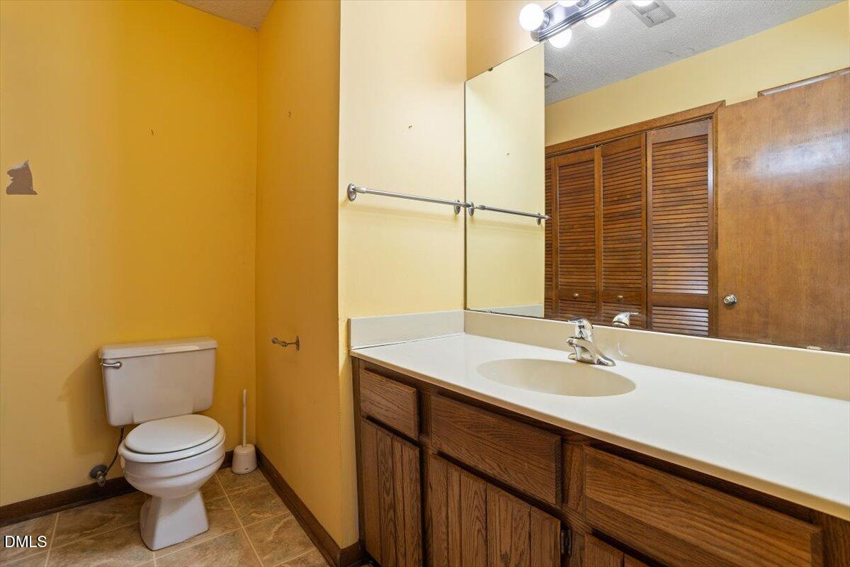 4329 Southwind Drive Raleigh, NC 27613 - Photo 12 of 30 a bathroom with a sink and a mirror