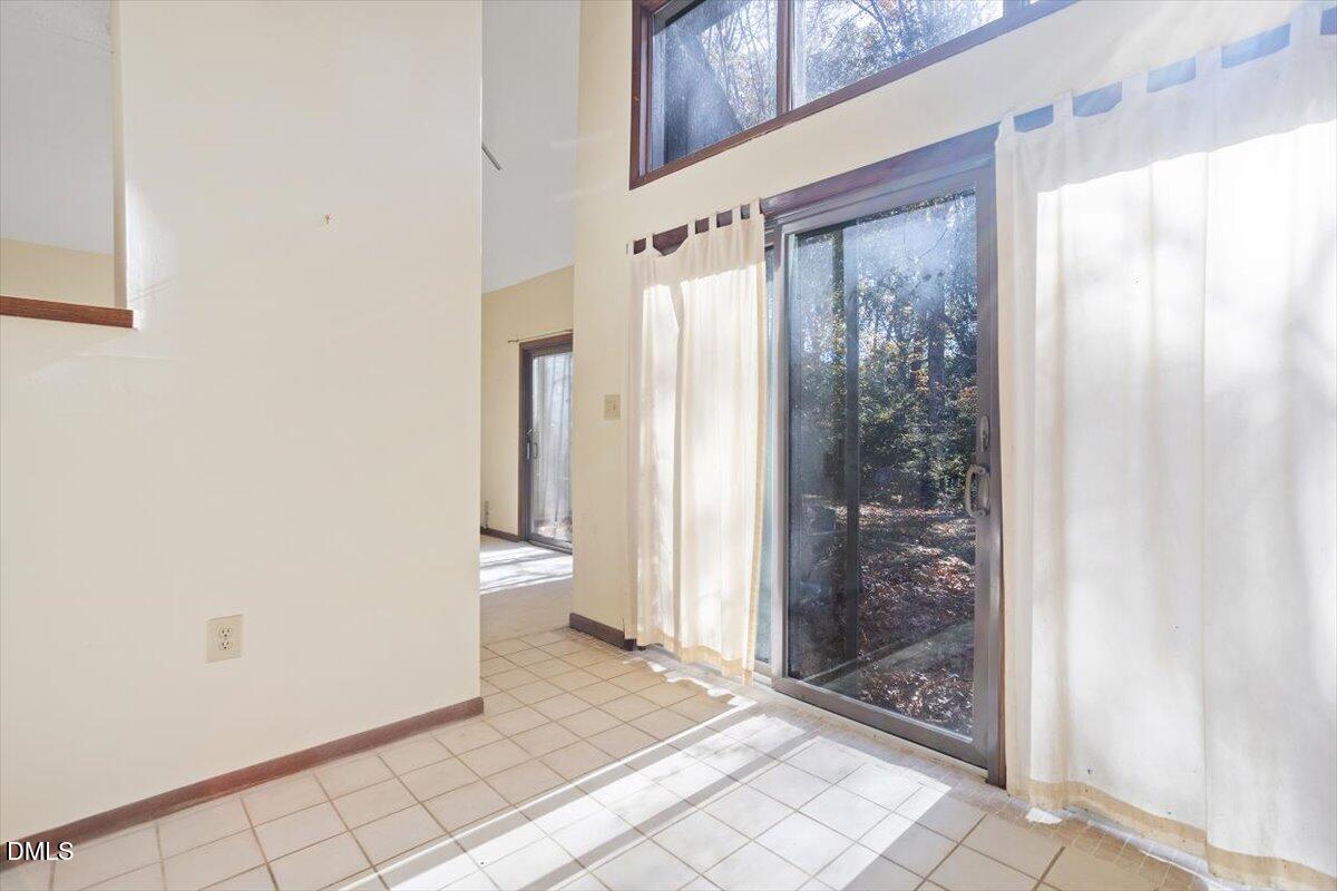 4329 Southwind Drive Raleigh, NC 27613 - Photo 17 of 30 a view of a hallway with wooden floor and a bathroom