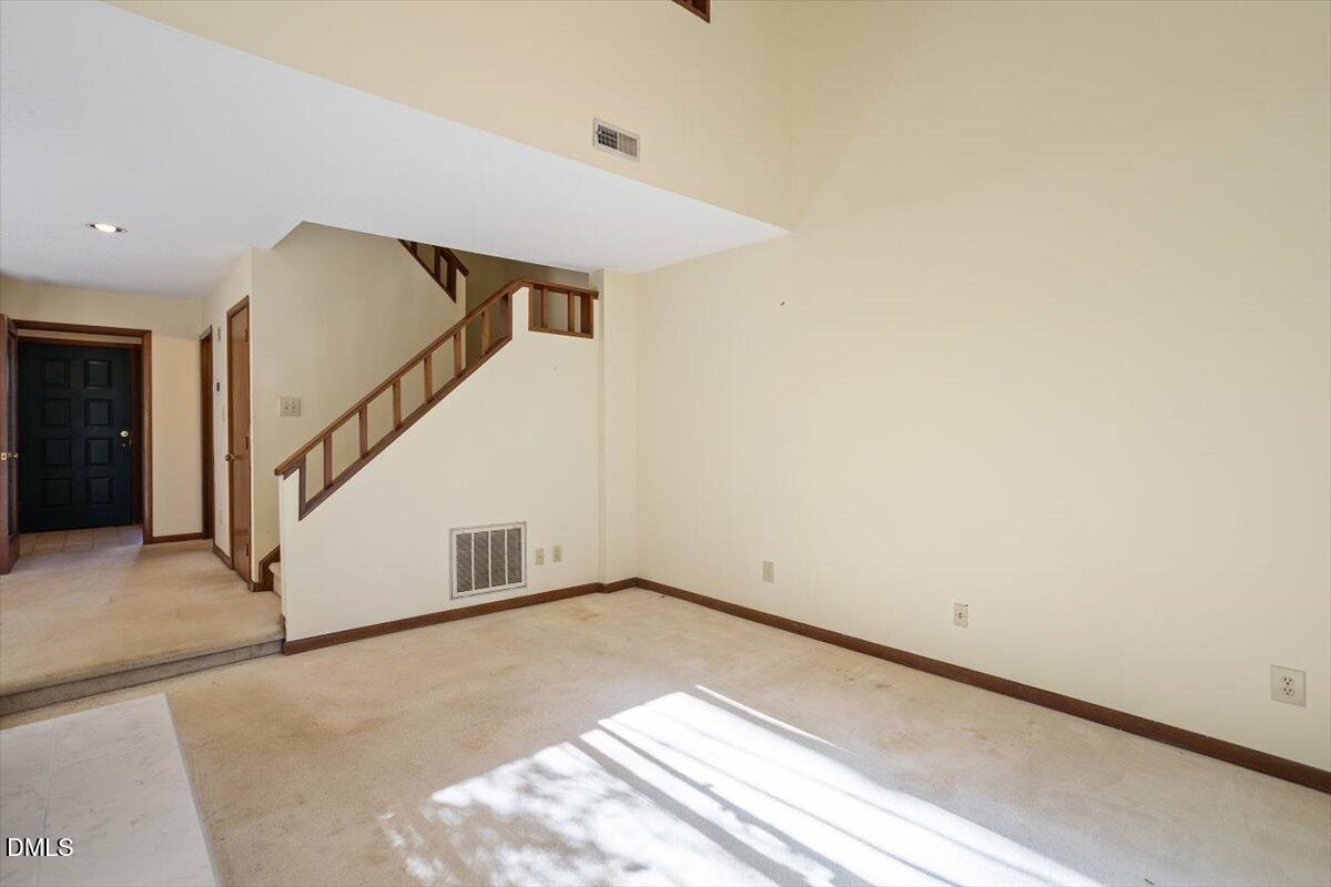 4329 Southwind Drive Raleigh, NC 27613 - Photo 19 of 30 a view of an empty room with stairs