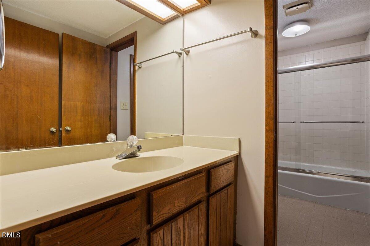 4329 Southwind Drive Raleigh, NC 27613 - Photo 24 of 30 a bathroom with a sink and a mirror