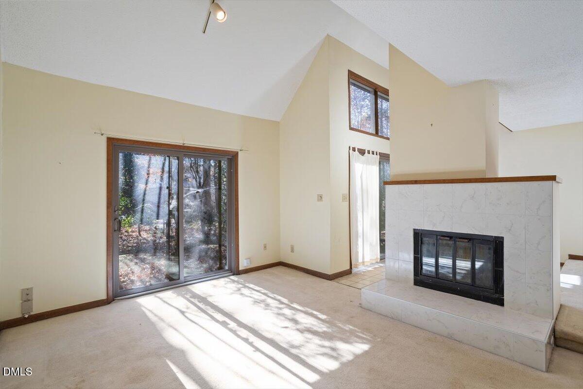 4329 Southwind Drive Raleigh, NC 27613 - Photo 6 of 30 a view of an empty room with window and fire place